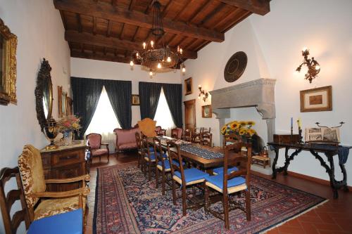 a living room with a dining table and chairs at Palazzo Tarlati - Hotel de Charme - Residenza d'Epoca in Civitella in Val di Chiana