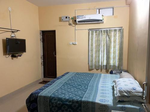 a hospital room with a bed and a tv at Divine view - 1 bhk AC - Swarna Bhavan in Puri