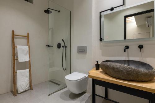 a bathroom with a sink and a toilet and a mirror at Lido Blue Villa in Pefki Rhodes