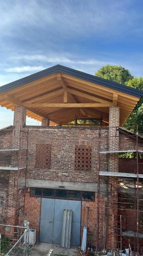 a building being constructed with a wooden roof on top at Inviting 2-Bed Apartment in Resana in Resana