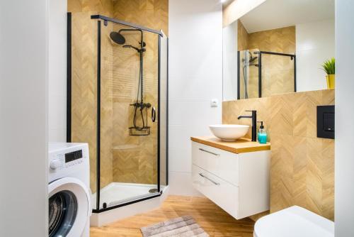 a bathroom with a shower and a washing machine at ApartamentySnu, Struga Tower Silver z parkingiem in Radom