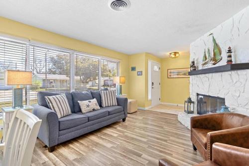 a living room with a couch and a fireplace at Perfect for Family Gatherings with a Heated Pool! - Clearwater's Clear Choice in Clearwater