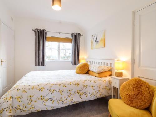 a bedroom with a bed with a teddy bear on it at Rector's Retreat in Ipswich