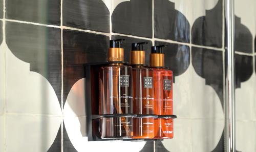 a group of four oxygen bottles on a wall at H10 Casa de la Plata in Seville