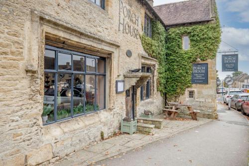 a brick building with a window on a street at Church View Apartment in Stow on the Wold