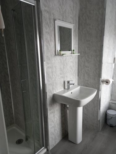 a bathroom with a sink and a shower at Crossroads House in Carlisle