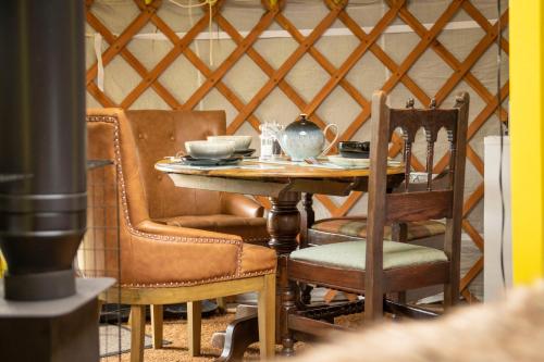 a dining room with a table and chairs at Cherish Glamping in Askrigg