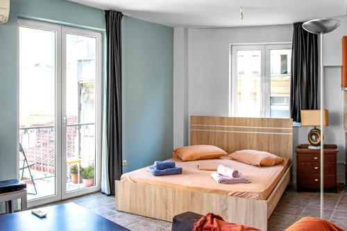 a bedroom with a bed and a large window at Loft in Athens