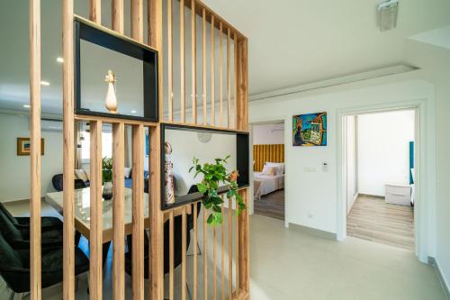 a living room with a wooden wall at Suite Petmat in Dubrovnik