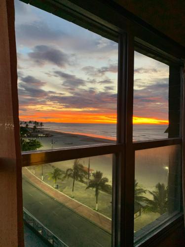 a view of the ocean from a window at Apartamento Centro Frente Mar-Mongaguá in Mongaguá