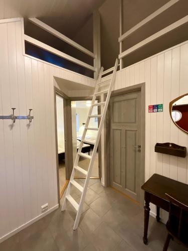 a ladder in a room with a room with a door at Ocean View Tind Lofoten in Moskenes