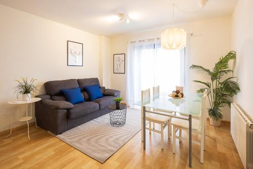 a living room with a couch and a table at Lucas House Apartments by Sitges Group in Sitges