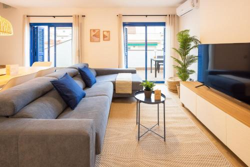 salon z kanapą i telewizorem w obiekcie Lucas House Apartments by Sitges Group w mieście Sitges