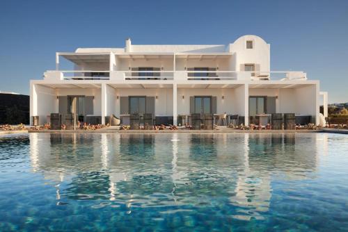 a white house with a swimming pool in front of it at Absolute Paradise Santorini in Akrotiri