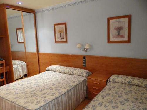 En eller flere senge i et værelse på Hotel Casa Carmen