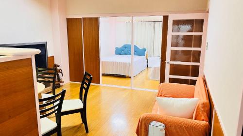 a living room with a bed and a chair at 田町ハウス in Takamatsu