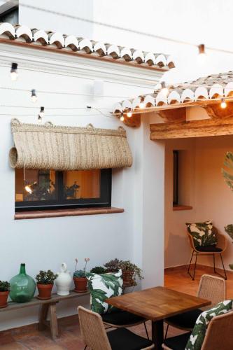 a patio with a table and chairs and a fireplace at The Adelante House in Jávea