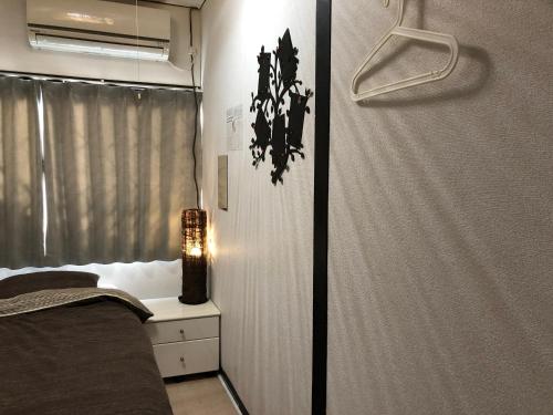 Ένα ή περισσότερα κρεβάτια σε δωμάτιο στο KYOTO Guest House