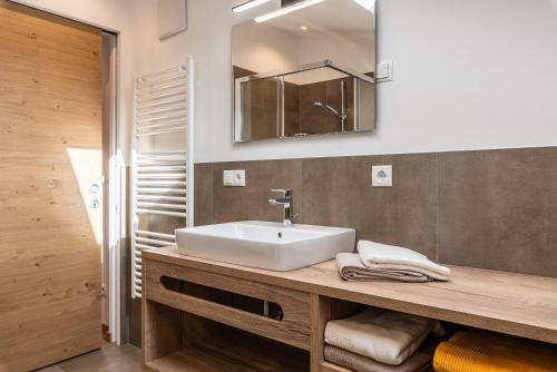 a bathroom with a sink and a mirror at Balbeinhof Apt Hirsch in Luson