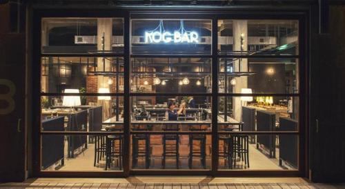 a restaurant front door with a sign in the window at Hotel Cycle in Onomichi