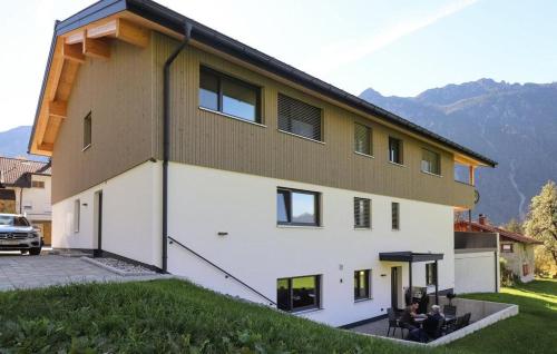 a large white building with two people sitting on a bench at Burtscherhof in Braz in Ausserbraz