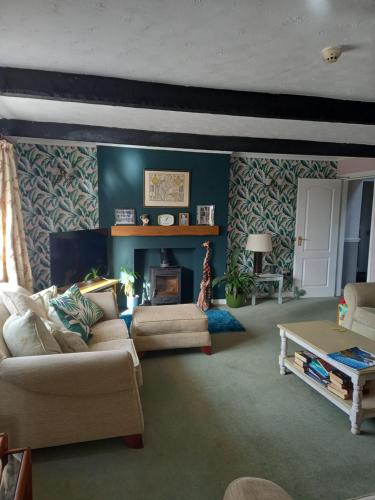 a living room with a couch and a fireplace at Crossroads House in Carlisle