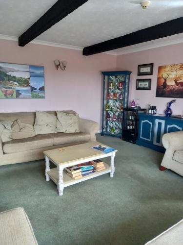 a living room with a couch and a coffee table at Crossroads House in Carlisle