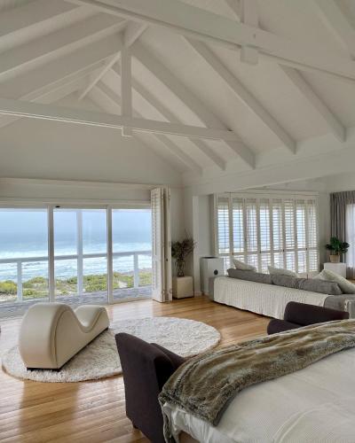 a large living room with a view of the ocean at White Sands Beach Villa in Yzerfontein