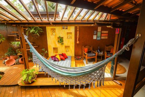 a hammock in the middle of a room at Beco Pousada Boutique in Fernando de Noronha
