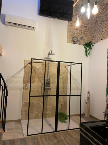 a glass shower in a room with a ceiling at Love House "L'évasion Secrète" in Rivesaltes