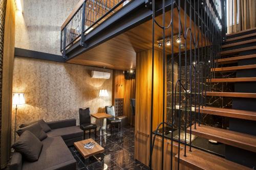 a living room with a couch and a staircase at Zuckmann Villa in Piešťany