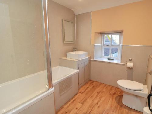 a bathroom with a toilet and a shower and a sink at Big Cottage in York