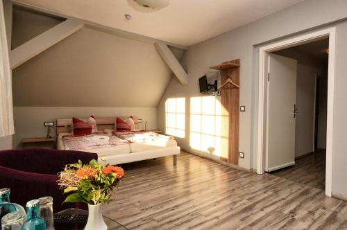 ein Wohnzimmer mit einem Bett und einem Sofa in der Unterkunft Hotel am Stadtwald in Stralsund