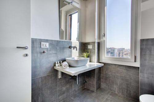 a bathroom with a sink and a mirror at ALTIDO Comfy flat with balcony in Milan