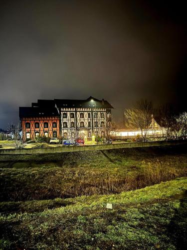 a large building in the middle of a field at Podu' cu Lanturi in Bacău