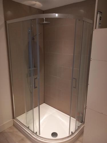 a shower with a glass enclosure in a bathroom at Number Five in Brighton & Hove