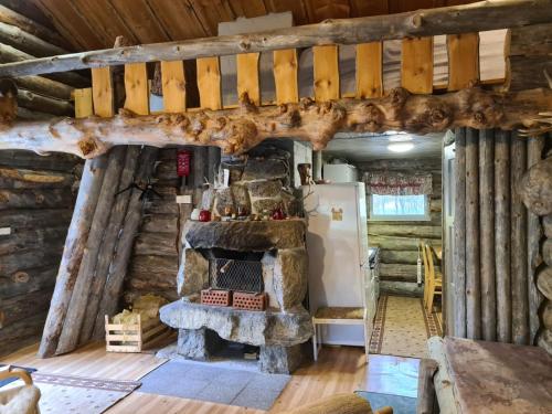 a kitchen in a log cabin with a refrigerator at Villa Lavijoki in Karesuvanto