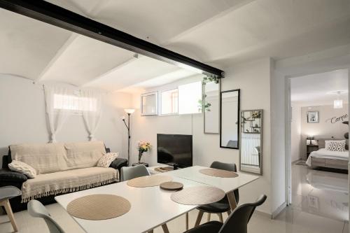 a living room with a table and chairs and a couch at vélodrome F4 dans villa 5 lits parking et piscine partagee in Marseille