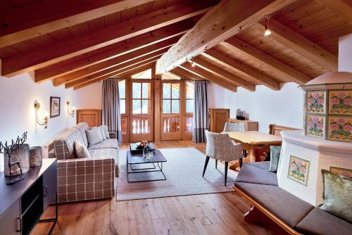 a living room with a couch and a table at Hotel Gletscherblick in Sankt Anton am Arlberg