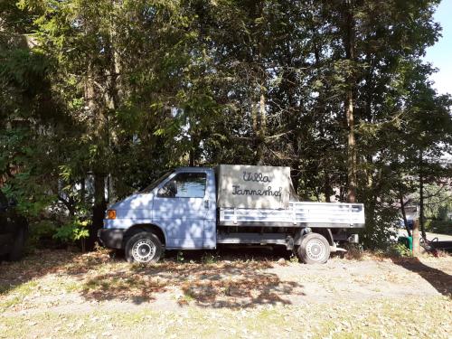 a blue and white truck parked in a field at Villa Tannerhof in Braunlage