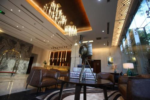 a lobby with a waiting room with a table and chairs at Empyrean Dhaka City Centre in Dhaka