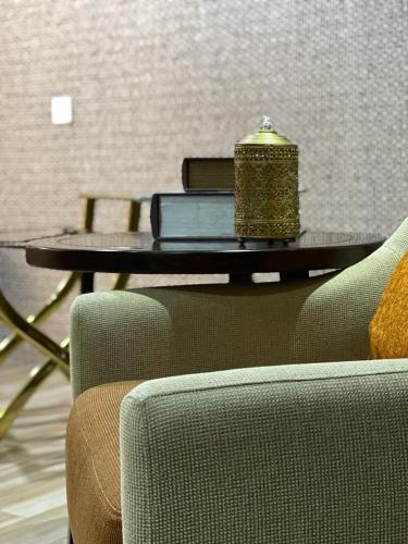 a table with a candle on it next to two chairs at Empyrean Dhaka City Centre in Dhaka