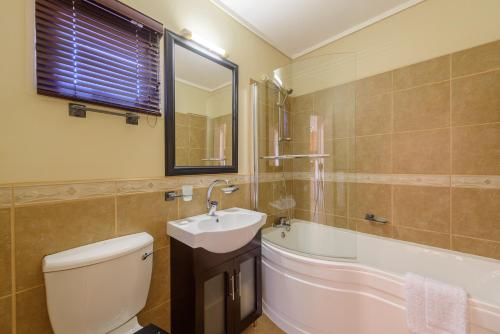 a bathroom with a toilet and a sink and a tub at San Lameer Villa 10425 - 1 Bedroom Classic - 2 pax - San Lameer Rental Agency in Southbroom
