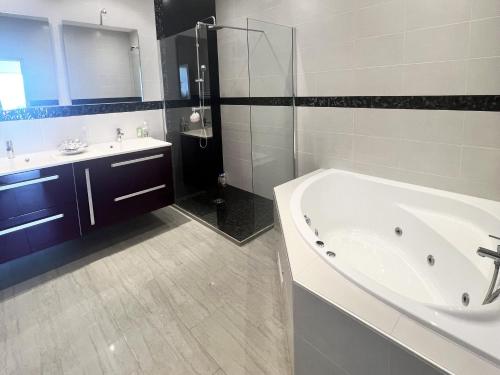 a bathroom with a tub and a sink and a shower at Luxurious studio suite near Monaco with sea view in Éze