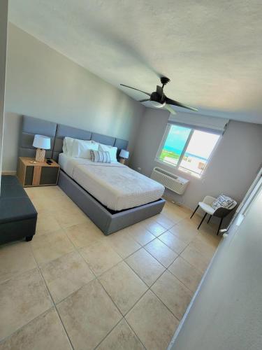 a bedroom with a bed and a ceiling fan at Hillside Village Retreat in Rio Grande