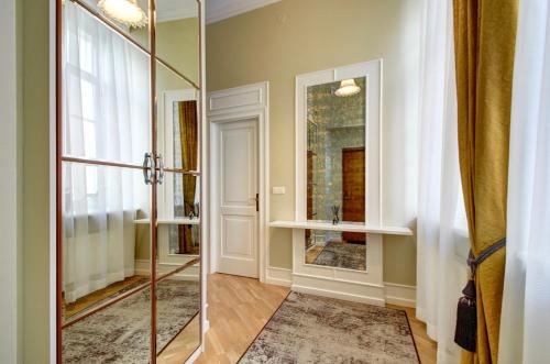 a bathroom with a walk in shower and a mirror at Vilnius Apartments & Suites – Old Town in Vilnius