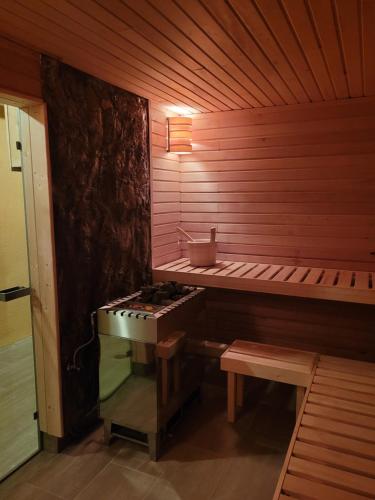 a sauna with a bench and a stove in it at Kunsthof Eibenstock in Eibenstock