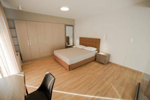 a bedroom with a bed and a wooden floor at Athens Heart Luxury Apartment in Athens