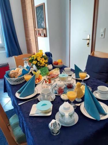 a table with a blue table cloth with food on it at Villa Tannerhof in Braunlage