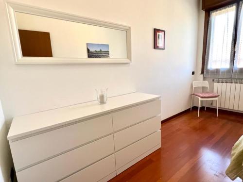 a white dresser in a room with a mirror at Todeschini 27 in Brembate